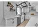 Modern kitchen with white shaker cabinets, quartz counters, and a pot filler at 6613 W Sweetwater Ave, Glendale, AZ 85304