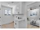 Laundry room with white cabinets and countertop, plus a window at 6613 W Sweetwater Ave, Glendale, AZ 85304