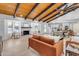 Sun-drenched living room with vaulted ceilings, fireplace, and views into the kitchen at 6613 W Sweetwater Ave, Glendale, AZ 85304
