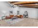 Living room features vaulted ceilings, a large orange couch and wood-toned coffee table at 6613 W Sweetwater Ave, Glendale, AZ 85304