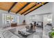Open living room with vaulted ceilings, light colored sofas, and a coffee table at 6613 W Sweetwater Ave, Glendale, AZ 85304