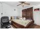 Cozy bedroom with double bed, ceiling fan, and plush toys at 6654 N 43Rd Ave, Glendale, AZ 85301