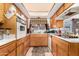 Kitchen with wood cabinets, oven, and cooktop at 6654 N 43Rd Ave, Glendale, AZ 85301