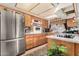 View of kitchen with stainless steel refrigerator and wood cabinets at 6654 N 43Rd Ave, Glendale, AZ 85301
