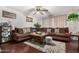 Spacious living room with brown sectional sofa and hardwood floors at 6654 N 43Rd Ave, Glendale, AZ 85301