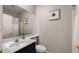 Clean bathroom with navy blue vanity, shower, and toilet at 6703 W Linda Ln, Chandler, AZ 85226
