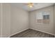 Bright bedroom featuring laminate wood flooring and window blinds at 6703 W Linda Ln, Chandler, AZ 85226