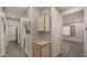 Clean hallway with wood-look floors and cabinets at 6703 W Linda Ln, Chandler, AZ 85226
