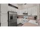 Modern kitchen with white cabinets and stainless steel appliances at 6703 W Linda Ln, Chandler, AZ 85226