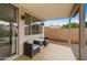 Covered patio with two wicker chairs and a small table at 6703 W Linda Ln, Chandler, AZ 85226