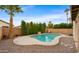 Relaxing kidney-shaped pool surrounded by a stone patio at 6703 W Linda Ln, Chandler, AZ 85226