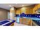 Kitchen with blue tile backsplash and wood cabinets at 74 N Muleshoe Rd, Apache Junction, AZ 85119