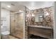 Modern bathroom with walk-in shower, mosaic tile, and floating vanity at 7438 E Hum Rd # 101, Carefree, AZ 85377