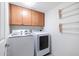 Laundry room with washer, dryer, cabinets, and drying rack at 7438 E Hum Rd # 101, Carefree, AZ 85377
