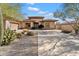 Inviting single-story home with mature desert landscaping and a spacious driveway at 7487 E Visao Dr, Scottsdale, AZ 85266