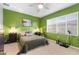 Bright bedroom with green walls, comfortable bed, and window blinds at 753 E Rojo Way # 102, Gilbert, AZ 85297