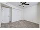 Bright bedroom with neutral walls, carpet, and a double door closet at 948 S Alma School Rd # 160, Mesa, AZ 85210