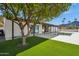 Landscaped backyard oasis with lush lawn and mature tree at 9626 N 17Th Pl, Phoenix, AZ 85020