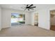Bedroom with backyard view, ceiling fan and ensuite bathroom at 9626 N 17Th Pl, Phoenix, AZ 85020