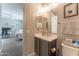 Modern bathroom with gray vanity, toilet and a view into a bedroom at 9814 E Sunspot Dr, Mesa, AZ 85212