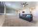 Spacious loft area with gray couch and ceiling fan at 9814 E Sunspot Dr, Mesa, AZ 85212