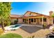 House exterior and backyard with covered patio and pool at 9930 W Burnett Rd, Peoria, AZ 85382