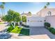 Front view of a charming home with a two-car garage and landscaping at 10155 E Topaz Dr, Scottsdale, AZ 85258