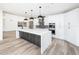 Modern kitchen with white cabinets, quartz countertops, and stainless steel appliances at 10155 E Topaz Dr, Scottsdale, AZ 85258