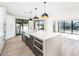 Modern kitchen with large island, stainless steel appliances, and white cabinetry at 10155 E Topaz Dr, Scottsdale, AZ 85258