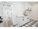 Clean laundry room with white cabinets and black accents at 10155 E Topaz Dr, Scottsdale, AZ 85258