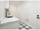 Modern laundry room with white cabinets and a black faucet at 10155 E Topaz Dr, Scottsdale, AZ 85258