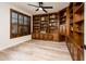 Built-in wooden library with ample shelving and storage at 10155 E Topaz Dr, Scottsdale, AZ 85258