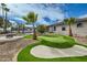 Spacious backyard oasis with putting green, fire pit, and mature palm trees at 10241 N Nicklaus Dr, Fountain Hills, AZ 85268