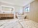 Spa-like bathroom with a freestanding tub, walk-in shower, and marble flooring at 10241 N Nicklaus Dr, Fountain Hills, AZ 85268