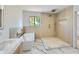 Spa-like bathroom with walk-in shower, soaking tub, and marble floors at 10241 N Nicklaus Dr, Fountain Hills, AZ 85268
