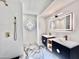 Bathroom with modern double vanity, marble flooring and a unique window accent at 10241 N Nicklaus Dr, Fountain Hills, AZ 85268