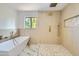 Spa-like bathroom with walk-in shower, soaking tub, and marble floors at 10241 N Nicklaus Dr, Fountain Hills, AZ 85268
