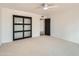 Bright bedroom featuring sliding barn doors and ceiling fan at 10241 N Nicklaus Dr, Fountain Hills, AZ 85268