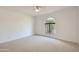 Bright bedroom with large arched window and ceiling fan at 10241 N Nicklaus Dr, Fountain Hills, AZ 85268