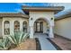 Front entry with arched doorway and landscaping at 10241 N Nicklaus Dr, Fountain Hills, AZ 85268