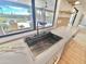 Modern kitchen sink with a built-in water filtration system and a view of the pool at 10241 N Nicklaus Dr, Fountain Hills, AZ 85268