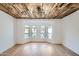 Bright living room with hardwood floors, large windows, and a rustic wood ceiling at 10241 N Nicklaus Dr, Fountain Hills, AZ 85268