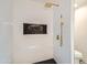 Modern shower with gold fixtures and pebble tile accent at 10241 N Nicklaus Dr, Fountain Hills, AZ 85268