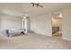 Spacious game room with air hockey table, ceiling fan, and neutral carpeting at 1036 E Oak Rd, San Tan Valley, AZ 85140
