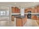 Kitchen with wood cabinets, granite countertops and island at 1036 E Oak Rd, San Tan Valley, AZ 85140