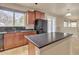 Kitchen with wood cabinets, granite countertops, and a large island at 1036 E Oak Rd, San Tan Valley, AZ 85140