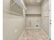 Laundry room with built-in shelving and tile flooring at 1036 E Oak Rd, San Tan Valley, AZ 85140