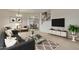 Living room featuring contemporary furniture and a large TV at 1036 E Oak Rd, San Tan Valley, AZ 85140