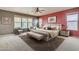 Main bedroom with sitting area, large bed, and accent wall at 1036 E Oak Rd, San Tan Valley, AZ 85140