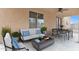 Covered patio with seating area and fire pit at 1036 E Oak Rd, San Tan Valley, AZ 85140